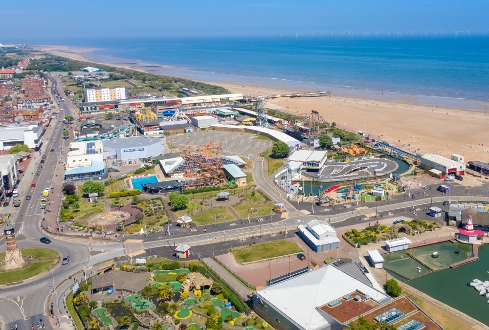 Aerial view of Skegness seafront, pier and beach, showing the indoor attractions available nearby when it rains