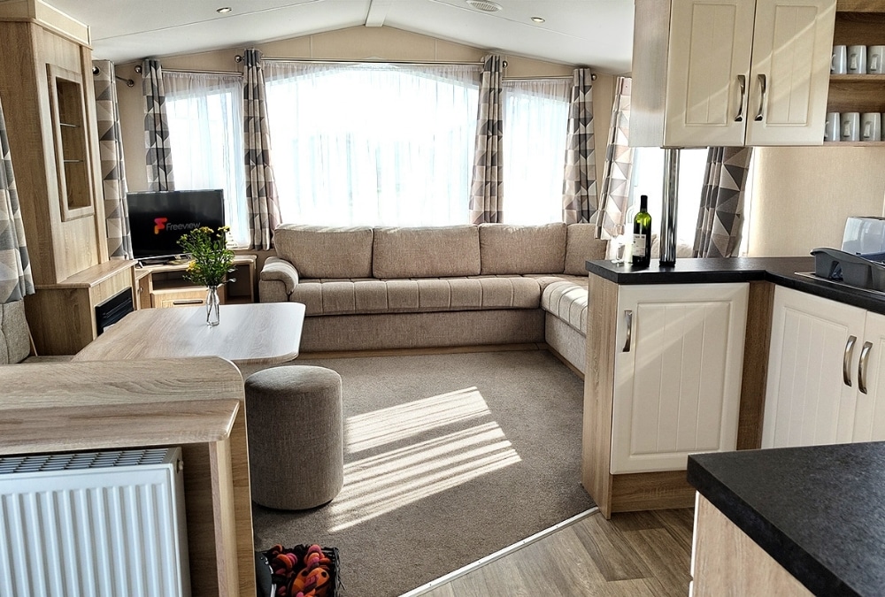 Living area and kitchen inside a Kingfisher Caravan Park holiday caravan in Ingoldmells