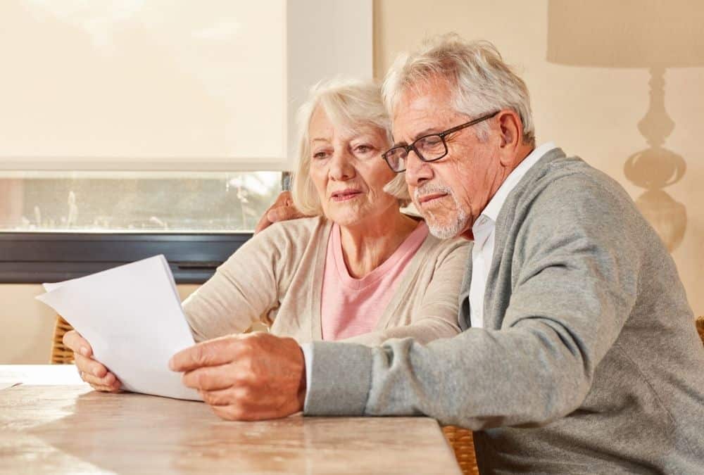 Couple reviewing finances and potential rental income from a static caravan