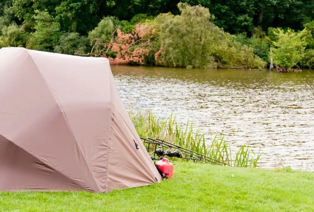 Carp fishing bivvy and rods set up beside a peaceful fishing lake near Skegness.