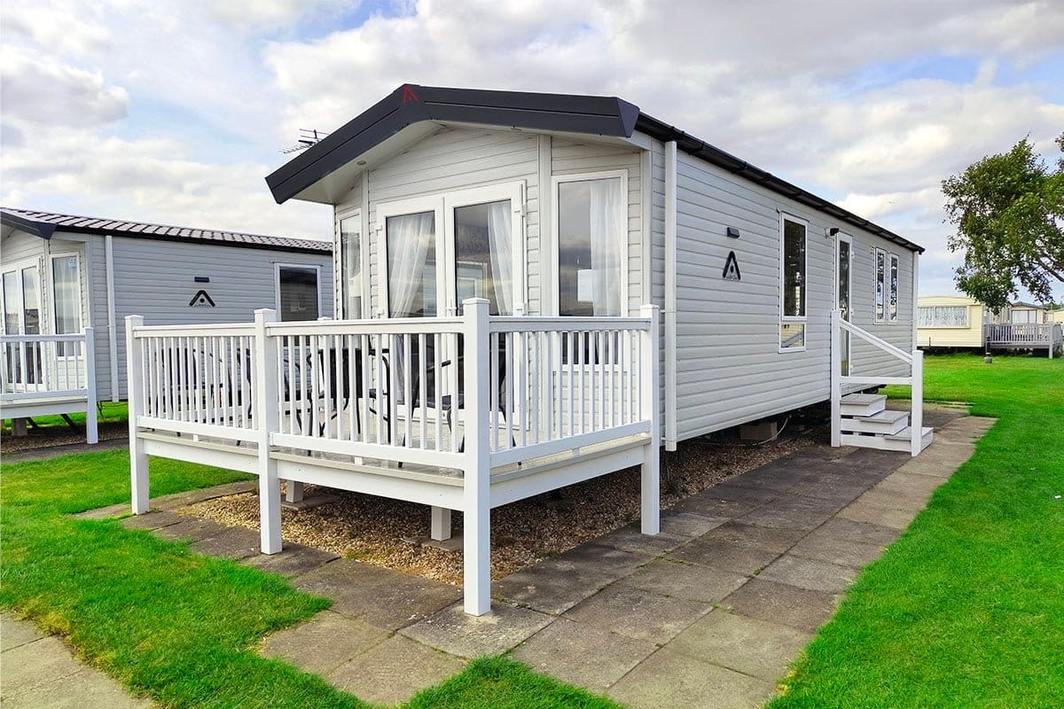 UK caravans for sale Premium Plus 2 Bedroom Pet-Friendly Caravan featuring steps and decking for easy access and outdoor enjoyment.