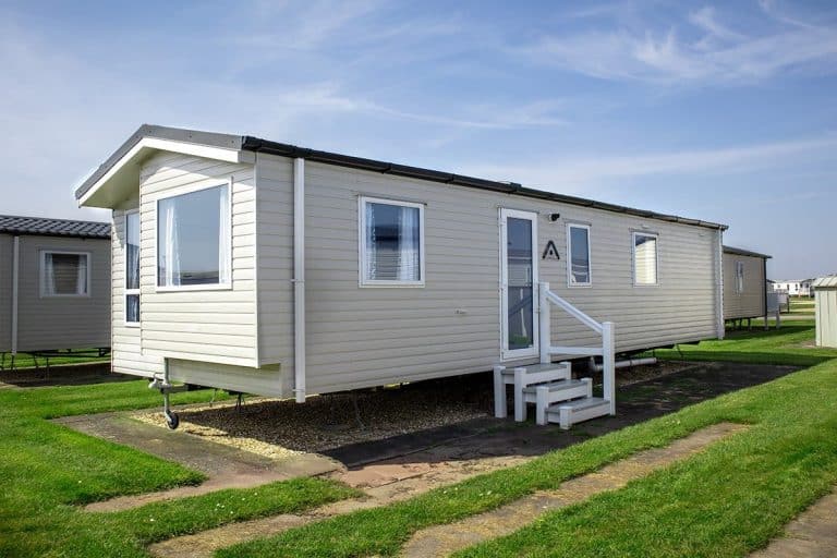 Static caravans for sale on site Exterior view of a Standard 2 Bedroom Pet-Friendly Caravan with steps leading up, providing easy access to a comfortable holiday home.
