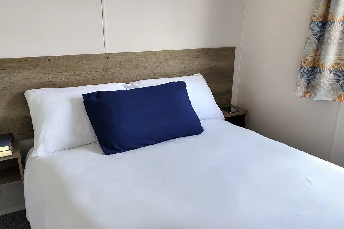 Master bedroom in a Standard 3 Bedroom Caravan with a standard double bed, ideal for a cosy and restful stay.