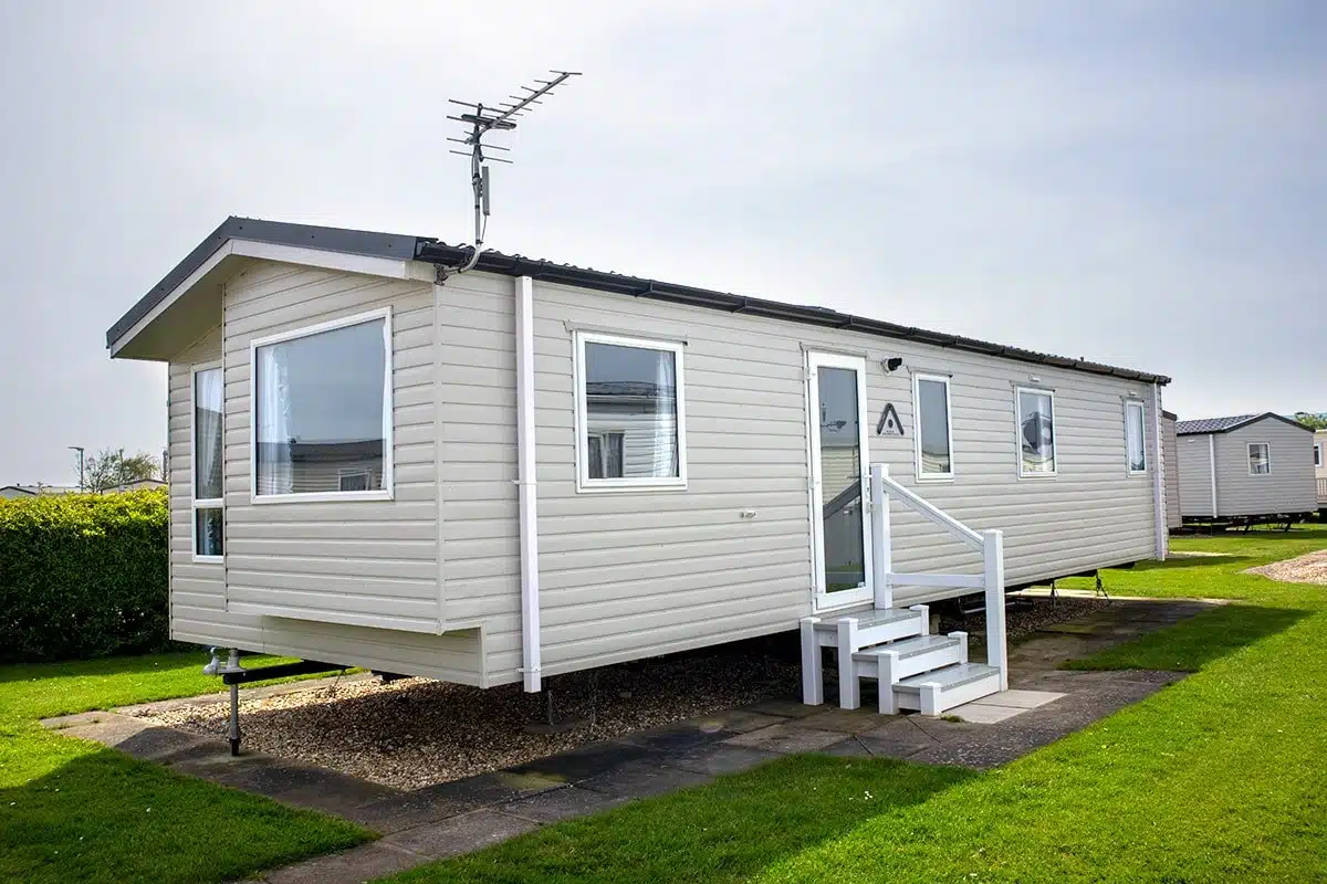 Exterior of a Standard 3 Bedroom Caravan with steps leading into it, offering a comfortable and affordable holiday home.