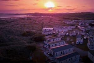 Holiday caravans overlooking coastal dunes at sunset on the Lincolnshire coast