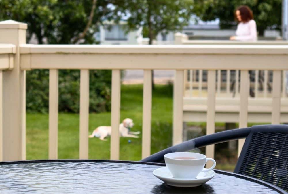 Morning cup of tea on caravan decking at a holiday park in Ingoldmells