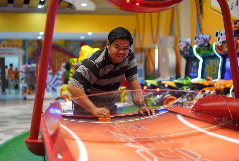 Family enjoying games inside a Skegness arcade with bright lights and interactive machines
