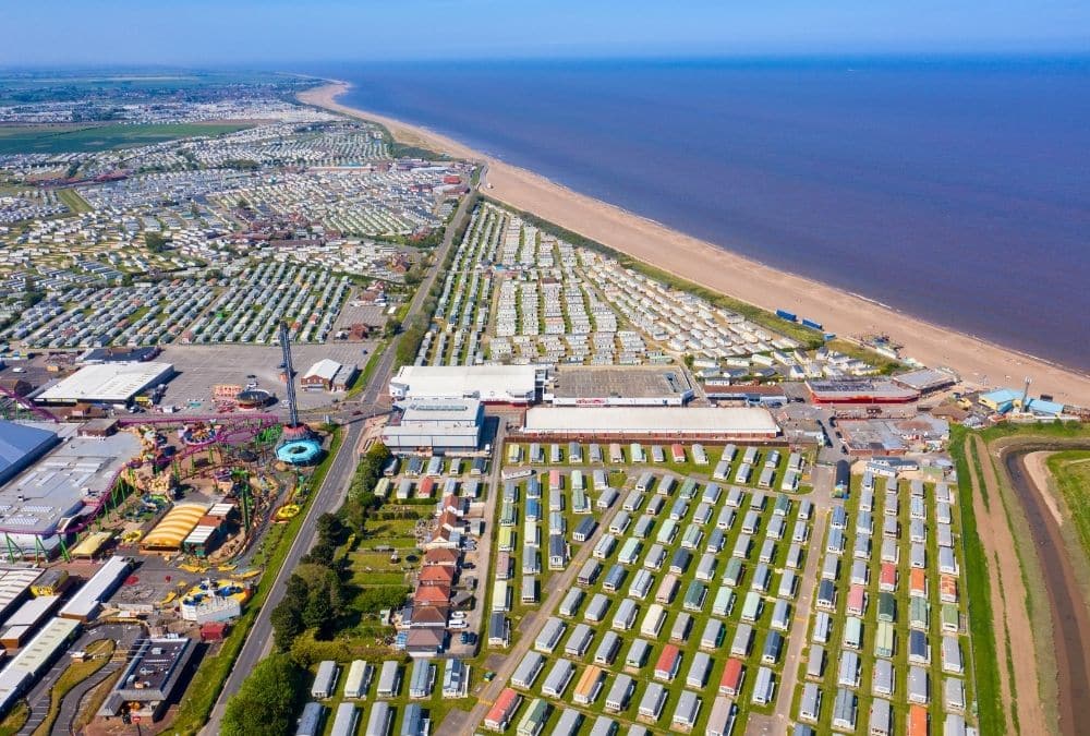Aerial view of Skegness coastline and caravan parks showing area around Skegness arcade attractions