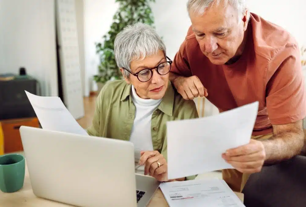 An elderly couple going through static caravan insurance documents
