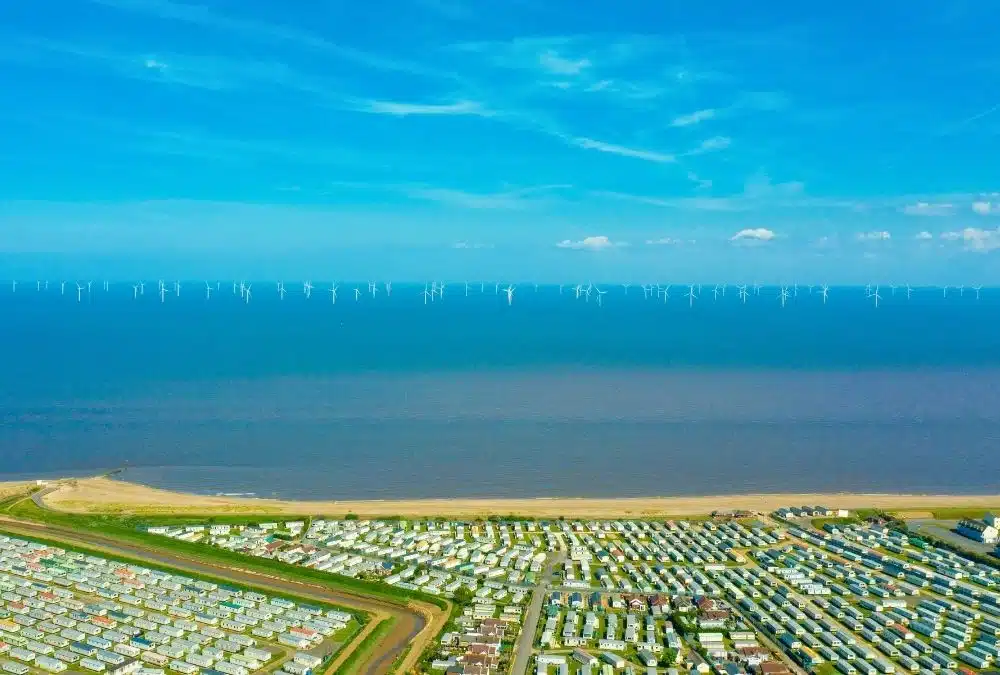 A mix of UK holiday parks with rows of static caravans at Ingoldmells, Skegness. The sea is on the horizon
