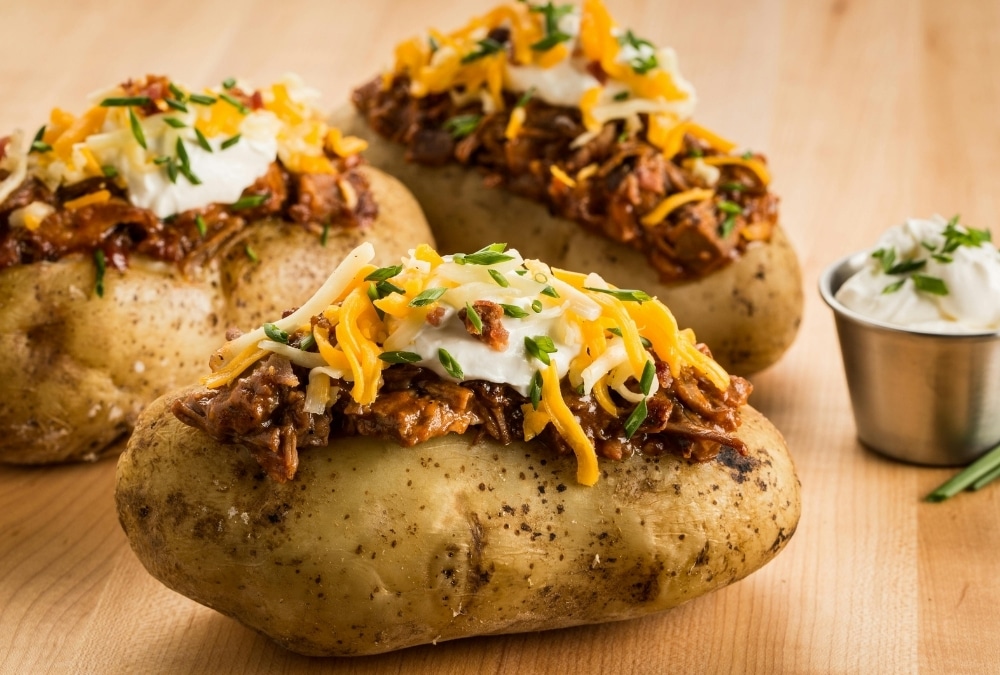 Loaded jacket potatoes topped with a hearty filling, cheese, soured cream and chives