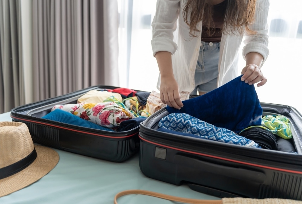Woman packing swimwear and towels for a Skegness water park trip