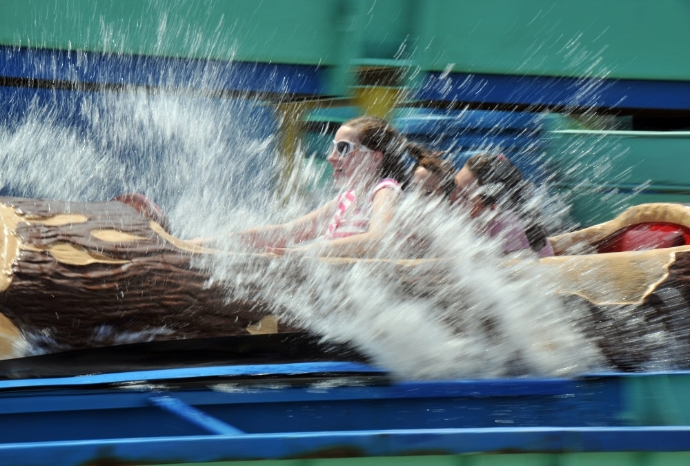 Visitors enjoying a splashing water ride at an amusement park, illustrating family attractions near Ingoldmells.